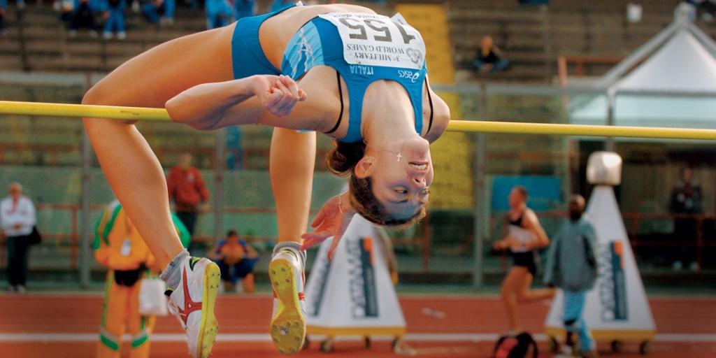 A high jumper clears a bar.