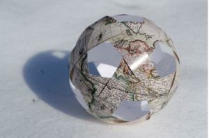 A soccer ball wrapped in maps
