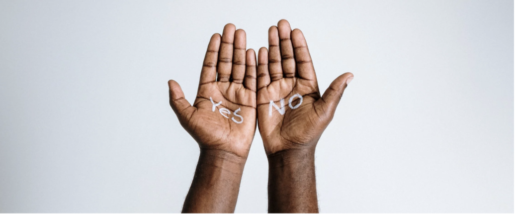 image of two hands. The word "yes" is written on one palm, and the word "no" is written on the other.